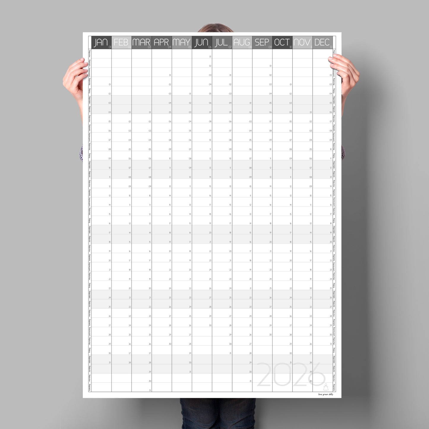 A lady holding up a giant calendar