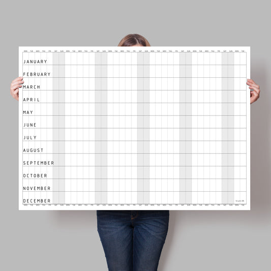 lady holding up large blank monochrome wall calendar