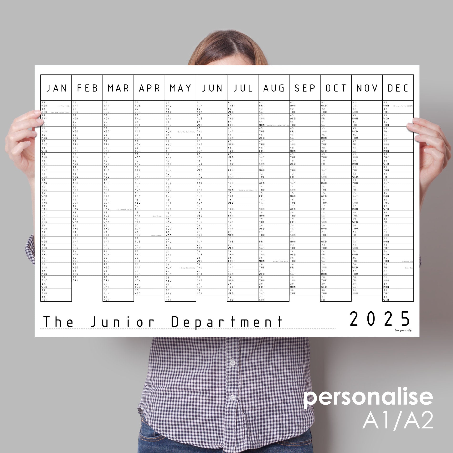 Lady holding up black and white wall planner for 2025