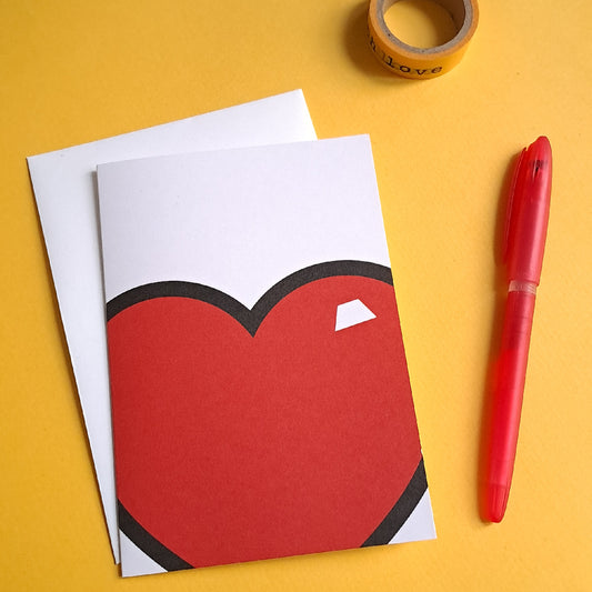 white greeting card with red love heart