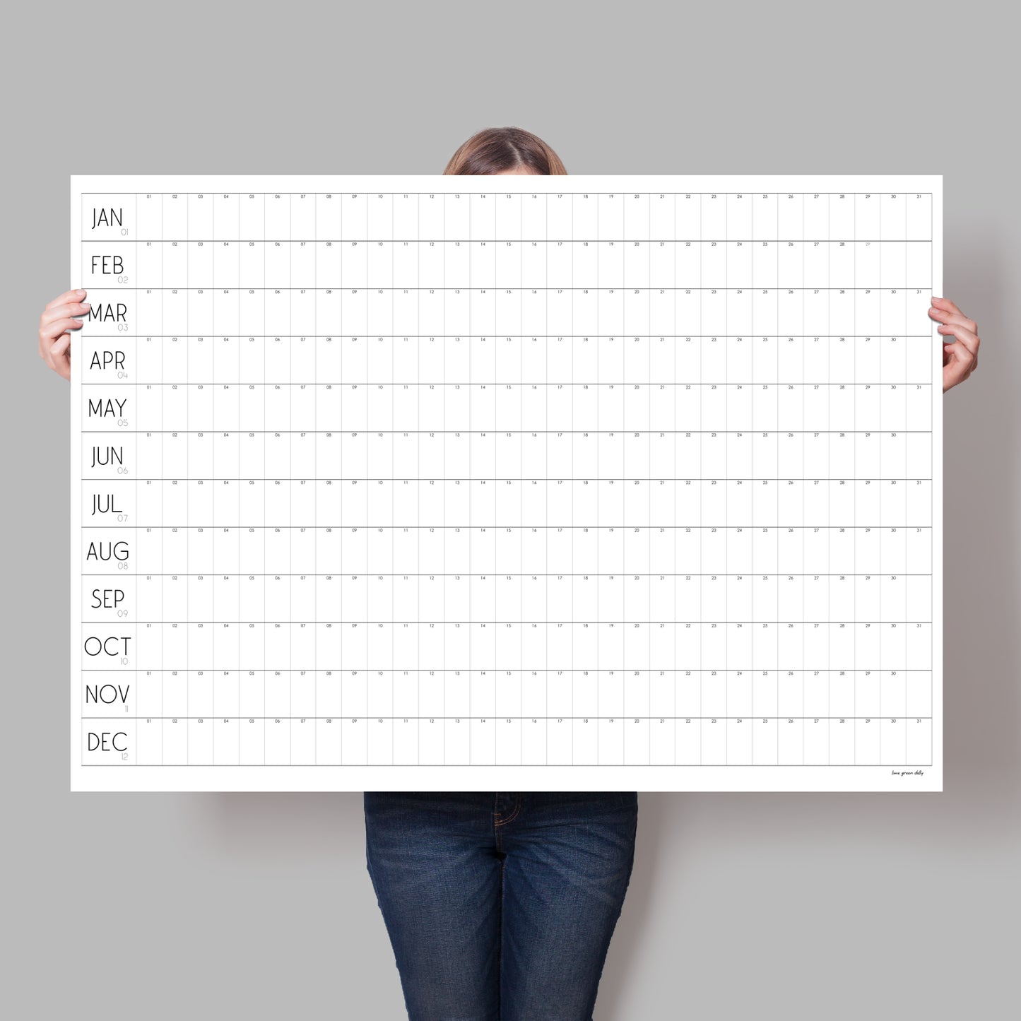 lady holding up large blank wall calendar