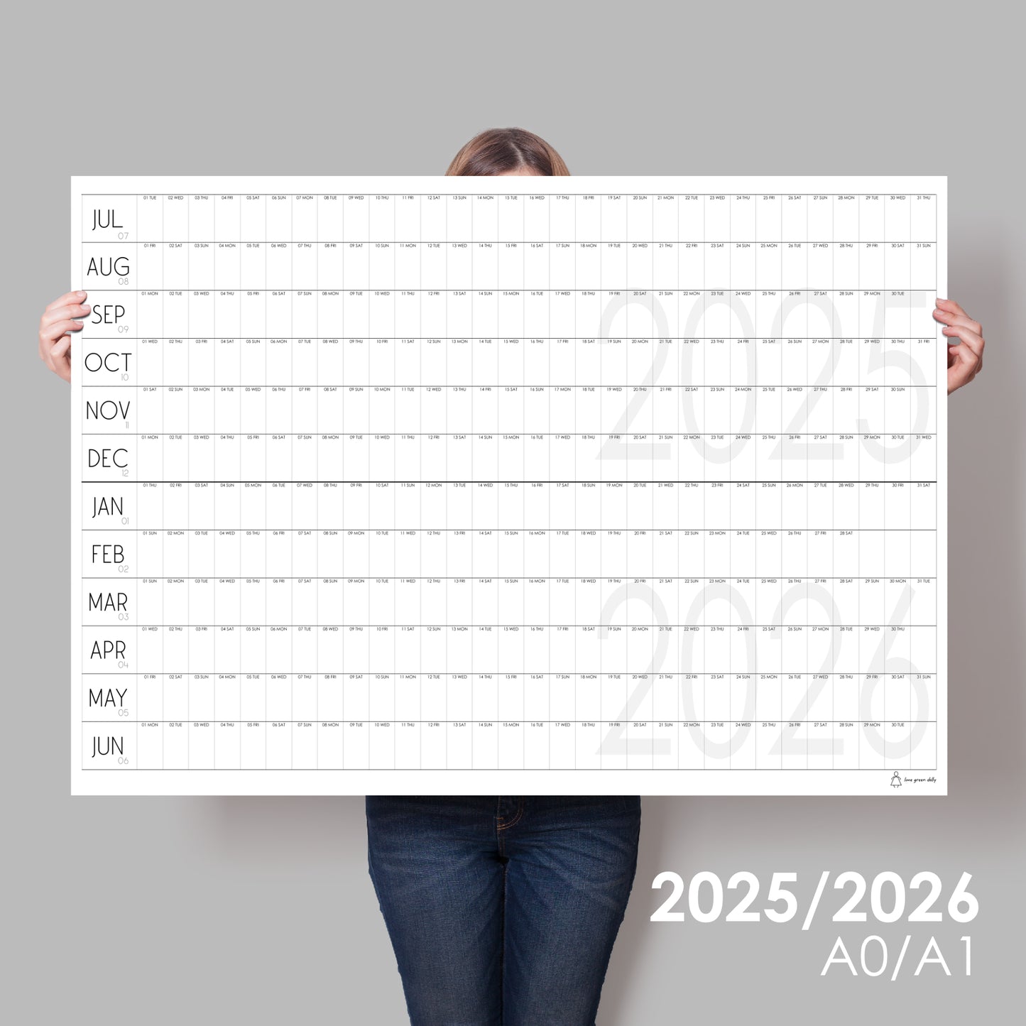 lady holding up extra large wall calendar for 2025/2026