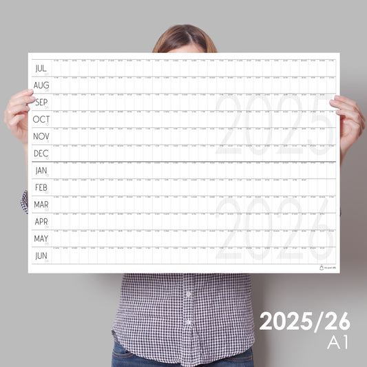 lady holding up large wall calendar for 2025/2026