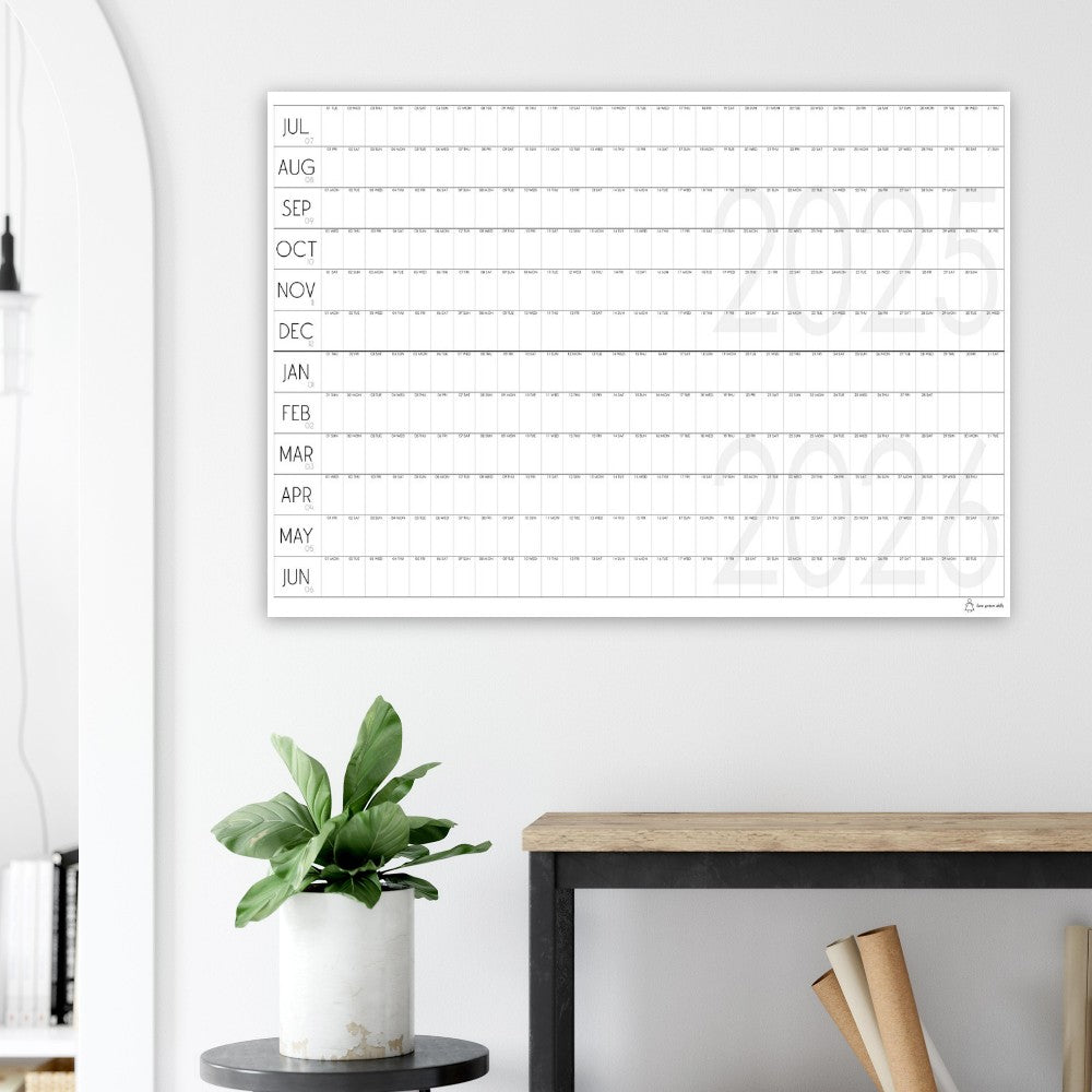 large paper calendar on grey wall above a work bench