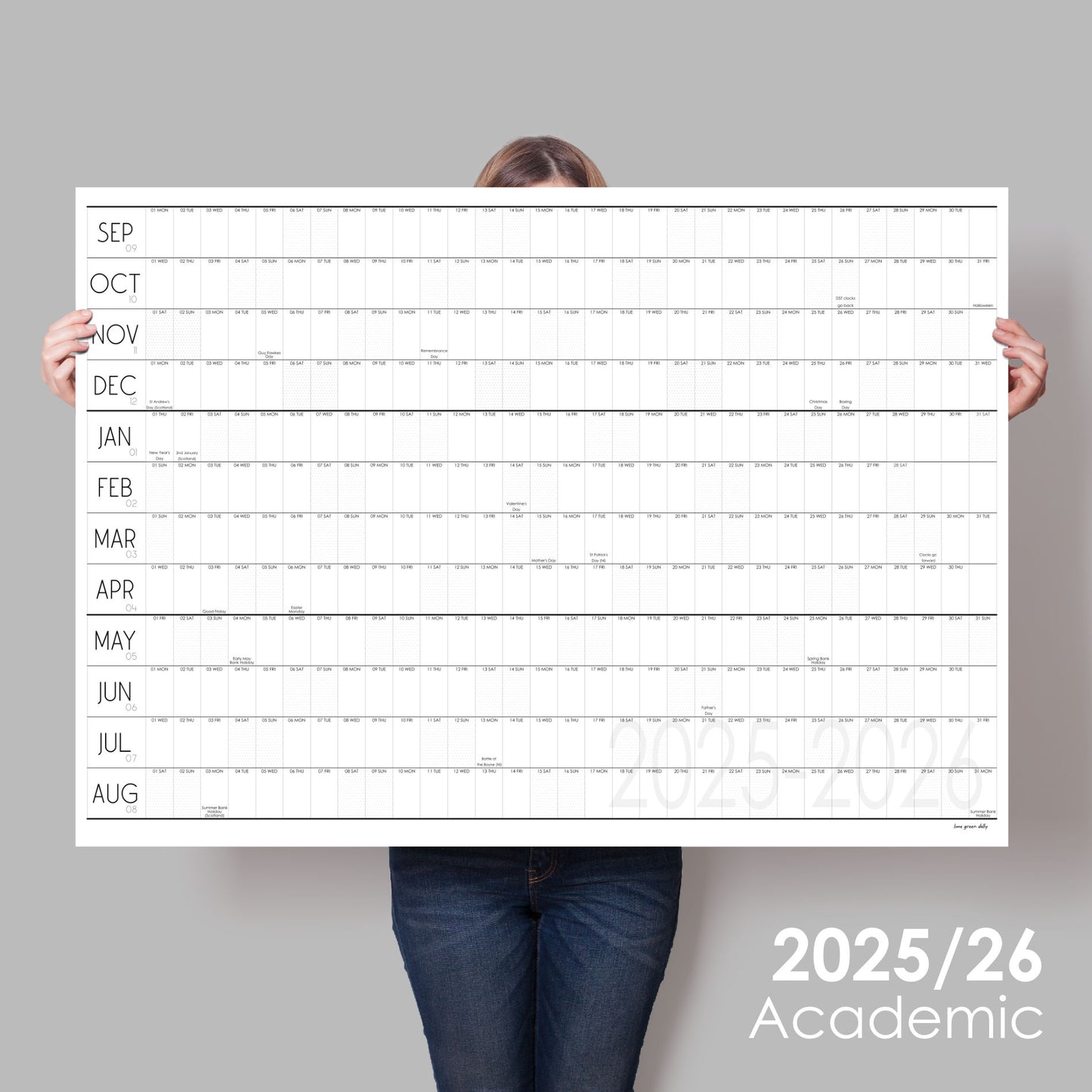 Lady holding up black and white wall planner for the academic year 2025 to 2026