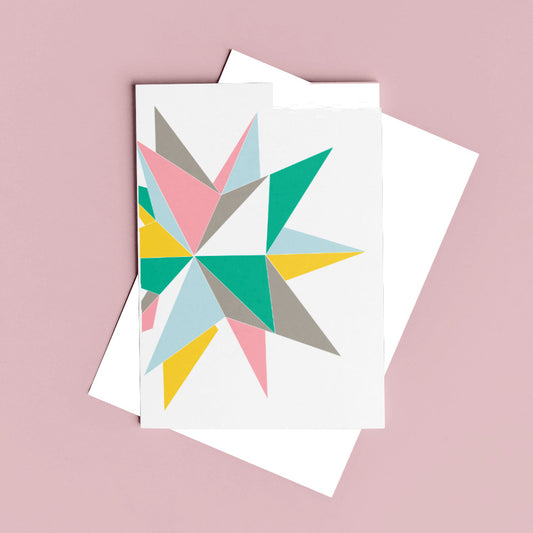 pastel greeting card with geometric shapes against a pink background