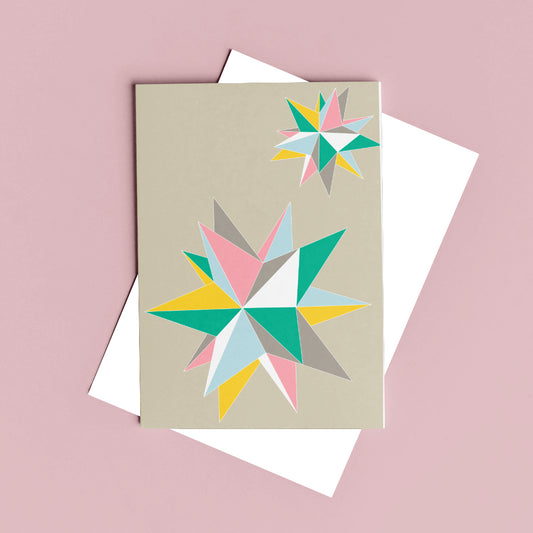 pastel greeting card with geometric shapes against a pink background