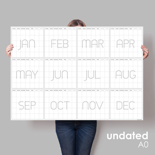 lady holding up giant wall planner with no dates