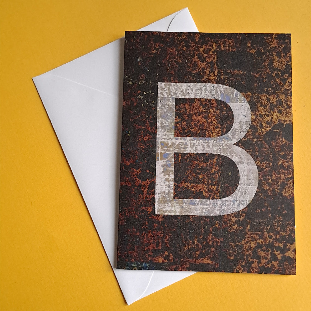 brown greeting card featuring the letter B against yellow background